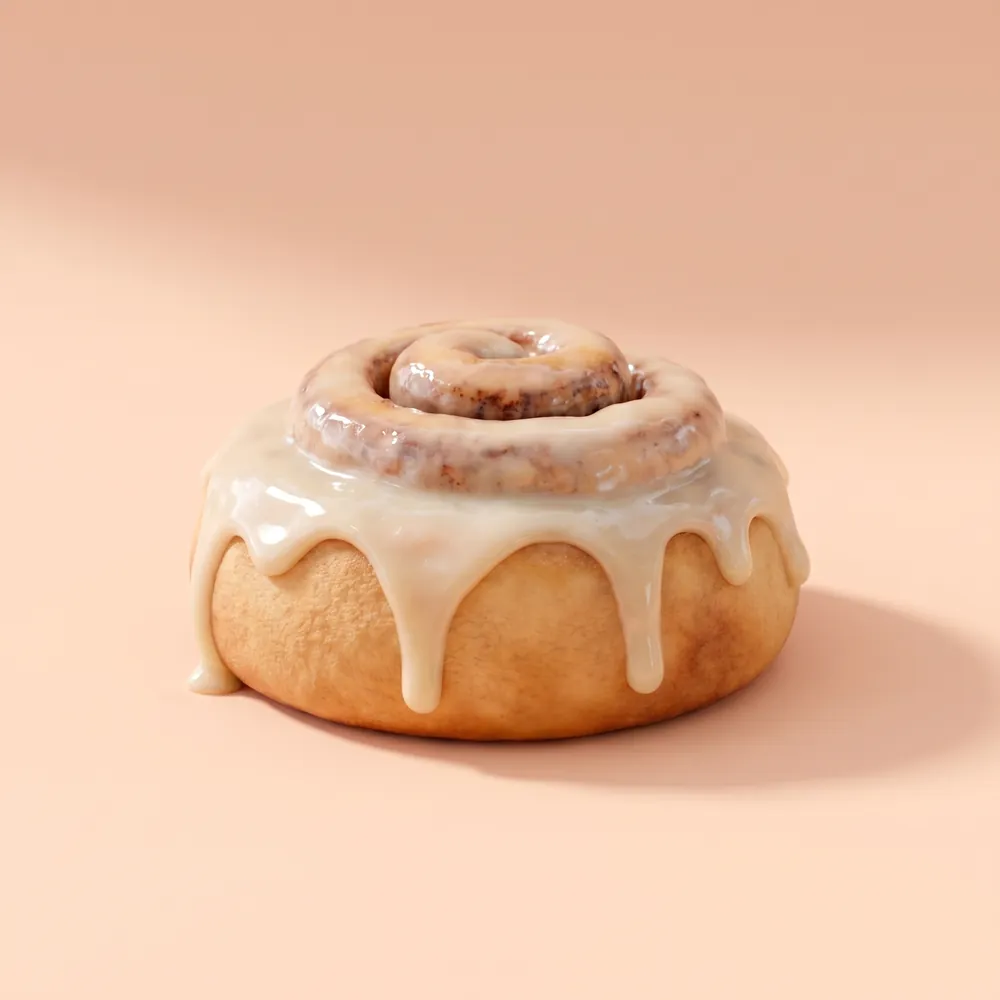 A soft cinnamon roll with thick vanilla glaze dripping down its sides, on a peach backdrop.